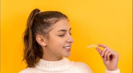 Girl considering clear aligner